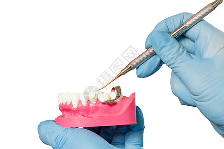 牙科医生的手与人下巴和牙齿修复仪器的布局探险家医生医疗橡皮工具牙医诊所金属治愈乐器图片