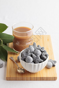 在白碗和木制板上 咖啡加酒盐咸沙尔米亚基糖果黑色氯化物食物铵盐桌子图片