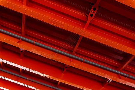 桥的亮橙色金属底座铆钉力量光束控制板框架城市旅行吸收安全生产图片