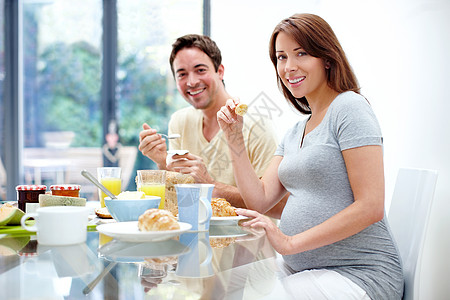 为了宝宝的健康 坚持下去 一对快乐期待的夫妇在家里吃健康早餐的肖像图片