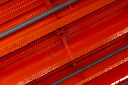 桥的亮橙色金属底座螺栓框架安全铆钉控制板城市商业吸收运输光束图片