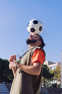 足球运动员平衡着头顶上的球图片