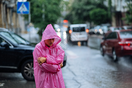 在雨中街上穿雨衣的可怜女人街道女孩季节照片女性冒充衣服白色外套黑发图片