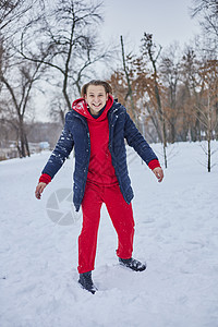 一个快乐的年轻人在冬季公园玩得开心 扔雪 手感寒冷 排放量不那么大夫妻森林闲暇家庭白色微笑喜悦乐趣幸福男性图片
