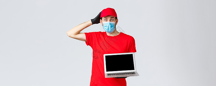 客户支持 共同提供19套交付包 在线订单处理概念 穿红色制服 面罩和手套 外表紧张 显示膝上型屏幕的困惑和担心信使工作男人服务载图片