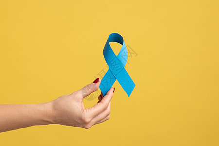 指甲着蓝色丝带 男性健康象征 前列腺癌意识的女性手图片