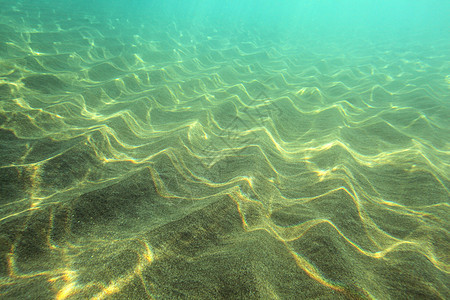 海底 阳光照耀下的沙“沙丘” 远处碧绿的海水 水下照片-抽象海洋背景图片