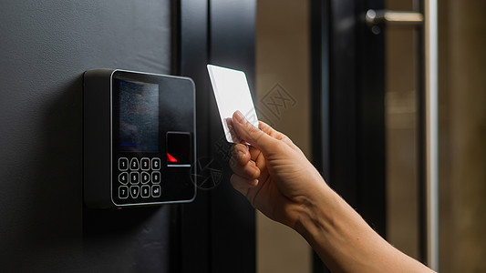 一个女人用塑料卡打开门 现代的无钥匙入口锁扫描住宿传感器机器鉴别检测客人保障控制开锁图片