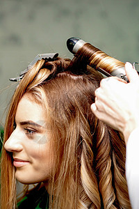 发型师用卷心铁做卷卷卷卷饼发型设计美容师电气工作室梳妆台女士女性客户理发造型师图片
