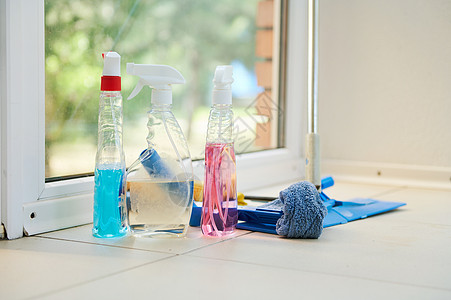清洁产品 家用化学品 洗涤剂 抹布和拖把在地板上与全景窗口背景相比图片