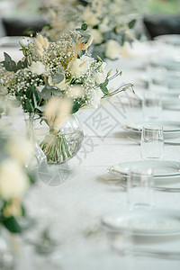 餐厅的婚礼接待台装饰了白蜡烛和鲜花 并配有白色蜡烛和鲜花接待乡村桌子盘子银器玫瑰花束风格庆典色调图片