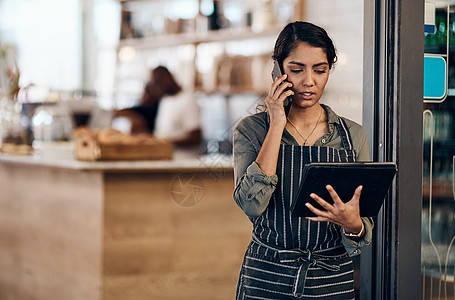 女性咖啡馆企业主在她的店里使用平板电脑通话 订购和阅读 严肃的女商务人士 企业家或雇员站在咖啡店准备在线杂货订单图片