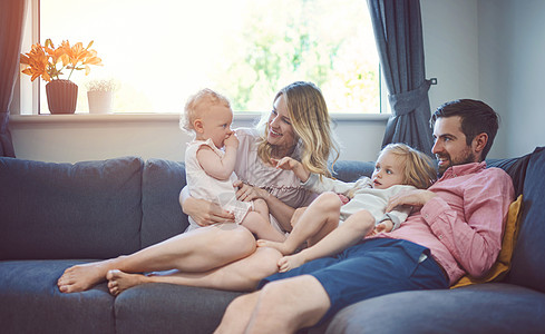 家庭目标 一个可爱的年轻家庭 有四个人在家里沙发上一起放松一下图片