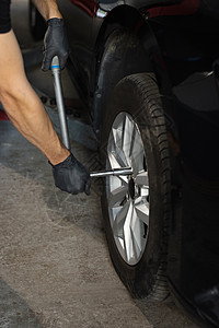 修理工在服务站安装车轮轮胎 汽车修理工在车库车间更换车轮轮胎 汽车服务图片