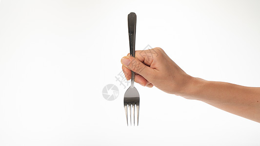 叉在一个女人的手 在白色背景的姿态上 刺在叉子上图片