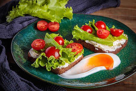 黑面包三明治 加融化的奶酪沙拉和西红柿 在绿色盘子上营养吃饭健康饮食早餐粮食团体乡村食物面包沙拉图片