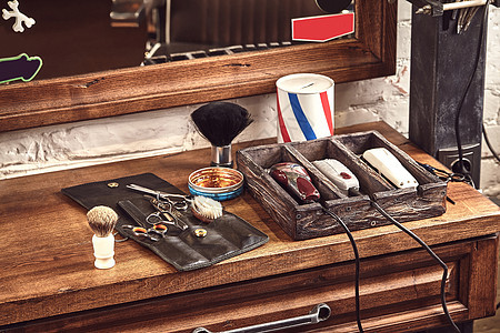 木制棕色桌子上的理发店工具 刮胡子和理发的门廊职业店铺服务收藏剪刀沙龙配件男人胡须木头图片