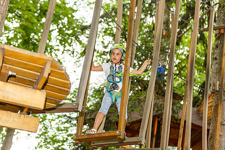 快乐的学校女孩在暑假享受在一个爬山冒险公园的活动活动场地活力天空喜悦幸福安全孩子们蹦床运动花园图片