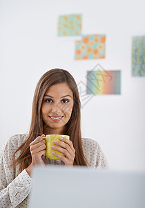 我不再喝咖啡了 但是我还不太喜欢 坐在办公室里拿着一杯咖啡的年轻女人的肖像图片