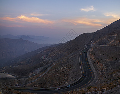 从Jebael Jais山到阿拉伯联合酋长国旅行岩石沥青马角日落柏油天空太阳假期顶峰图片
