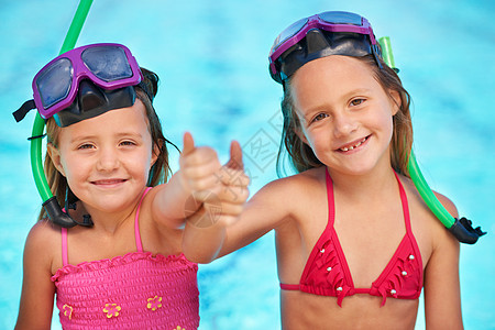 两个可爱的小女孩在泳池穿泳衣时 举起拇指露出拇指游泳衣泳装水池金发幸福女孩游泳面具家庭假期图片