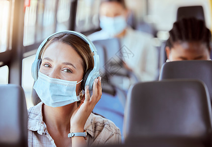 Covid 旅行和音乐 供女性在公共汽车旅行或交通工具上戴口罩 以确保安全 免受 covid 19 病毒的侵害 戴着耳机流媒体或图片