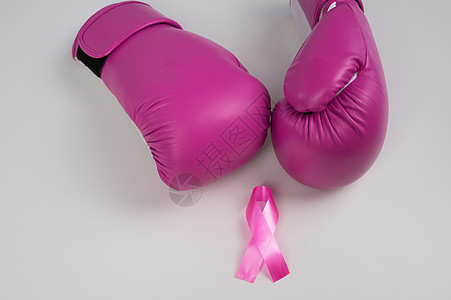 粉色拳击手套和白色背景的粉红色丝带 乳腺癌概念风险x线拳头预防疾病女性照片癌症斗争磁带图片