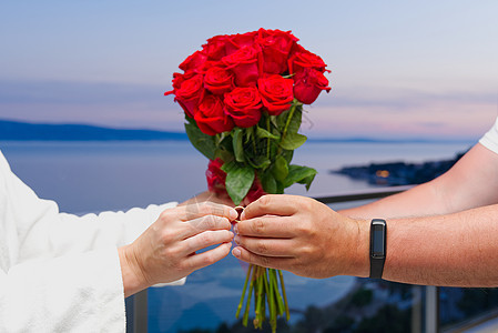 男人在度假时给他的女人一个订婚戒指 无法辨认的婚戒手指惊喜女士妻子未婚礼物夫妻新娘情人庆典图片