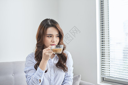 在沙发里放松 喝茶的开心女人女孩咖啡杯子窗户女性牛奶背景图片