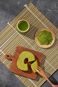 Matcha 绿色茶拿铁在杯子和茶叶仪式上用德国蛋糕配餐具白色小吃甜点食物抹茶糕点圆形粉色图片