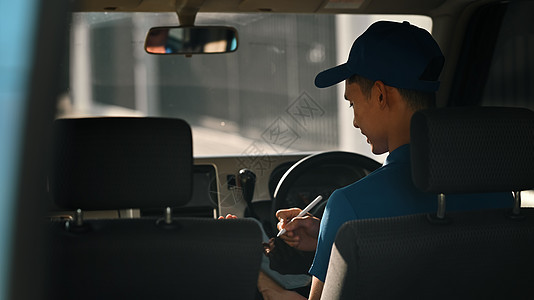 亚洲男性快递员在装满包裹的货车中使用数字平板电脑 送货服务 运输和运输概念图片