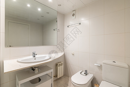 简单的白色浴室 有大镜子 经典水槽 浴盆和厕所图片