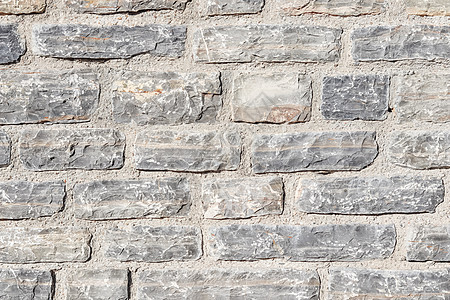 灰色天然石墙的近底背景地面石灰石花岗岩建筑学石板石灰华房子墙纸框架岩石图片