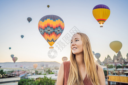 在土耳其卡帕多细亚看热气球的女游客 土耳其概念中的快乐旅行 山顶上的女人享受美妙的景色女士男人吸引力女孩假期地标夫妻航班冒险家庭图片