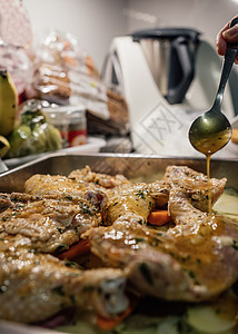准备烘烤的鸡肉上泼橄榄油的妇女用手把橄榄油倒在鸡身上图片