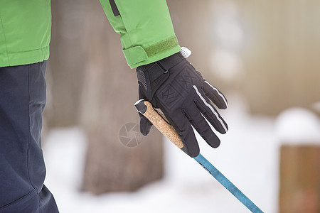 北欧式健走 健康的生活方式 冬季的户外运动 一个男人的手紧握着北欧式行走的拐杖把手 把一根棍子贴在你的手上冒险甘蔗闲暇远足运动公图片