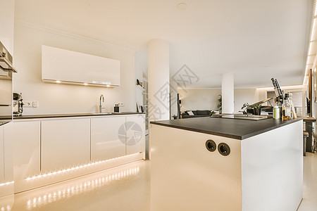 一个有白色柜子和黑柜子的厨房桌子住宅柜台浴缸公寓内阁沙发窗户房子家具图片