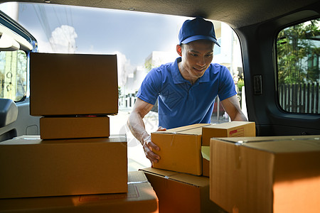 亚洲送货员从货车上卸下纸板箱 送货服务 送货上门和运输概念图片