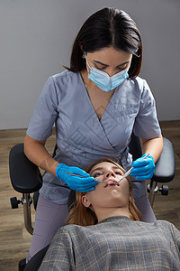 一名有牙镜的女病人牙科牙医检查牙牙牙矫正牙齿微笑药品镜子女性成人卫生医院健康图片