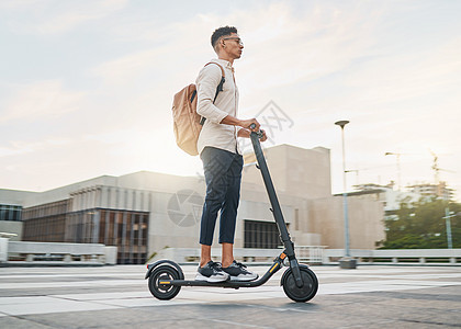 年轻人 骑滑板车和生态友好的无排放未来 可持续和户外 在白天通勤或旅途中 在城市街道上旅行 休闲商务人士和驾驶电动交通工具背景图片