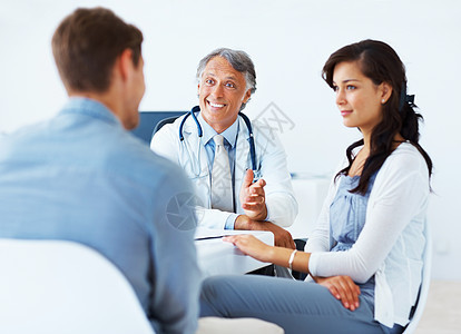 惊讶的医生和女人听男人说话 惊讶的成熟医生与女人在诊所听男人说话的画像图片