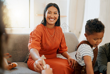 一个快乐的混血家庭在家里的沙发上玩耍和放松 爱的黑人家庭在沙发上嬉戏 年轻女子在家里与她的寄养孩子建立联系图片