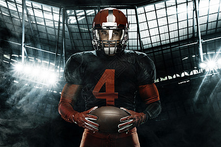 美国足球运动员的特写肖像 在大舞台背景上戴着红色头盔的运动员运动员 体育和动机壁纸行动体育场运动力量竞赛男人联盟团队大学黑暗图片