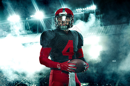 美国足球运动员的特写肖像 在大舞台背景上戴着红色头盔的运动员运动员 体育和动机壁纸赛跑者团队玩家竞赛体育场力量运动联盟游戏挑战图片