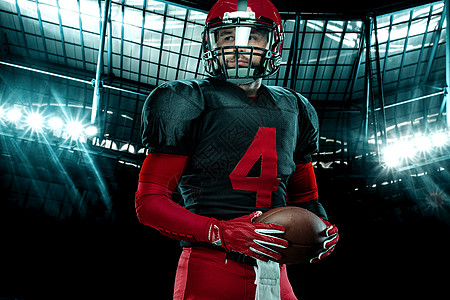 美国足球运动员的特写肖像 在大舞台背景上戴着红色头盔的运动员运动员 体育和动机壁纸大学竞赛男人男性赛跑者团队联盟运动游戏体育场图片