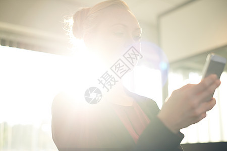 她的商业前途是光明的 一位有吸引力的女商务人士 在办公室用他的手机图片