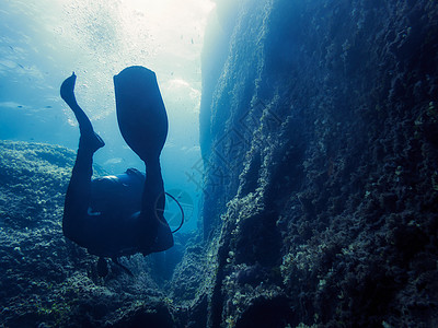 潜水员穿过岩石峡谷的轮廓潜水多样性野生动物热带脚蹼环境冒险家冒险爱好生态图片