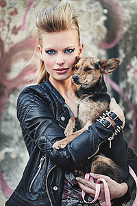 像我这样的摇滚巨星唯一的宠物 一个狂躁的年轻女人在城市环境中 抱着她的小狗被割下肖像图片