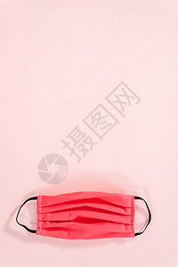 科罗纳病毒爆发防护设备装备自制口罩高架保护粉色面膜织物背景图片