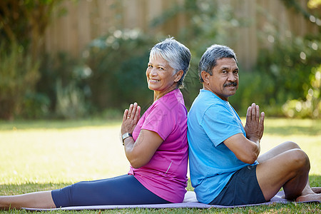 锻炼我们的身心 一对成熟夫妇在他们的后院一起做瑜伽的肖像图片